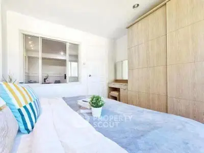 Bright and cozy bedroom with modern decor and ample natural light