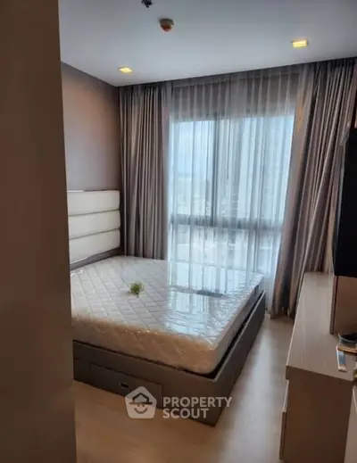 Cozy bedroom with large window and modern decor