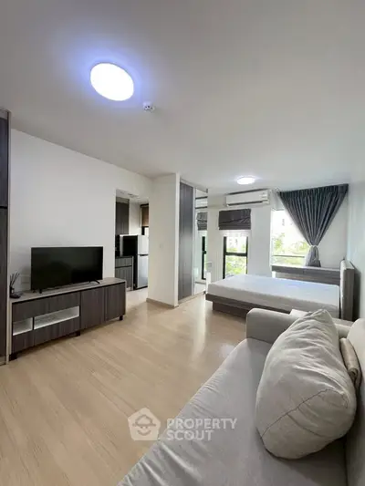 Modern open-plan living room with natural light and stylish furnishings