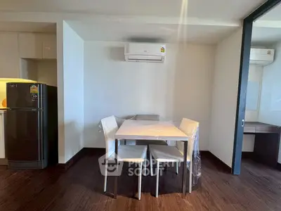 Modern dining area with air conditioning and sleek furniture in a stylish apartment.