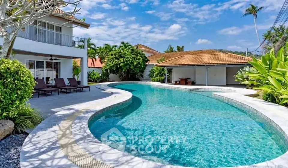 Luxurious villa with stunning pool and lush garden, perfect for tropical living.