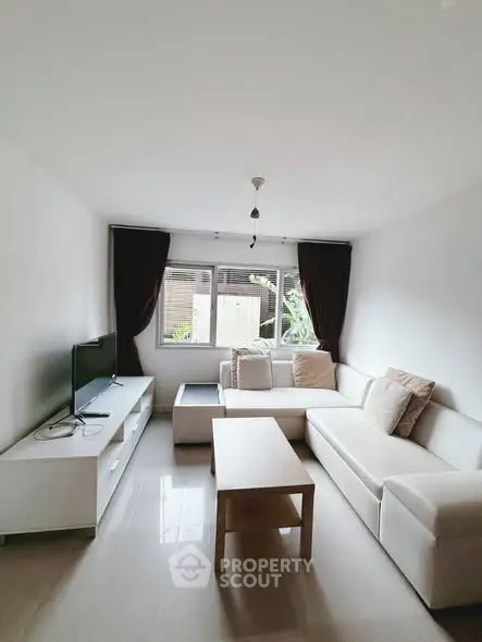 Modern living room with white sectional sofa and natural light