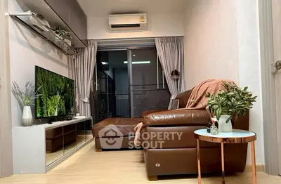 Cozy living room with leather sofa and modern decor in a stylish apartment.