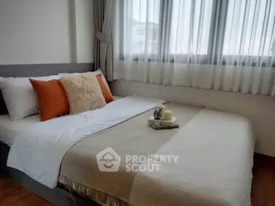 Cozy bedroom with natural light and stylish decor