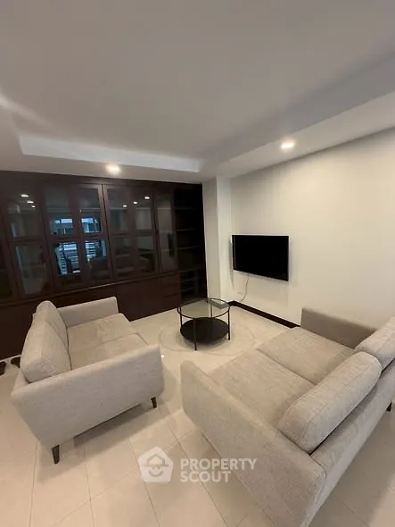 Modern living room with sleek furniture and built-in shelving