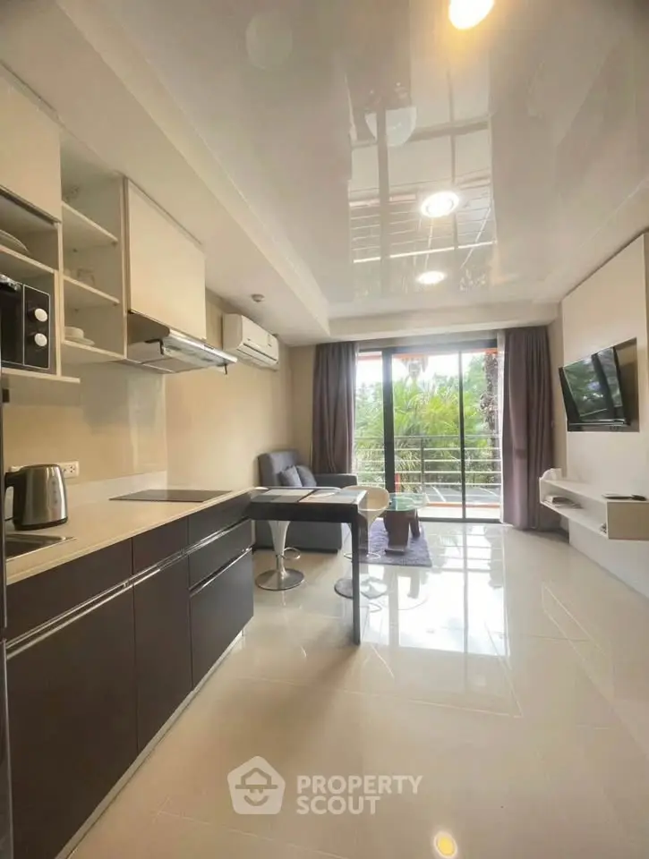 Modern living room with sleek kitchen and balcony view, featuring contemporary furniture and natural light.