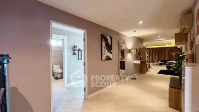 Spacious open-plan living area with modern decor and natural lighting