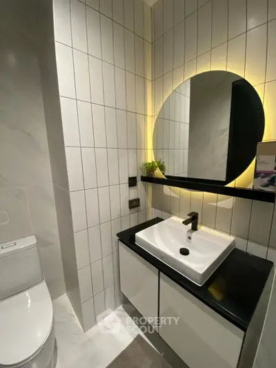 Modern bathroom with sleek design and illuminated mirror