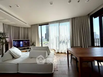 Spacious modern living room with large windows and stylish furniture