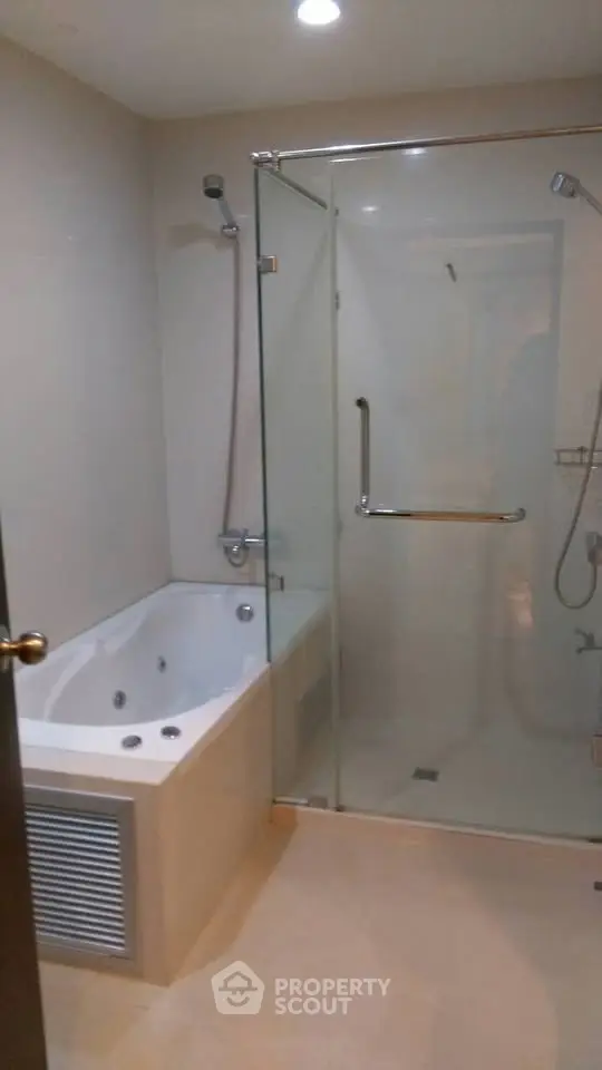 Luxurious bathroom with modern shower and bathtub in elegant real estate property.