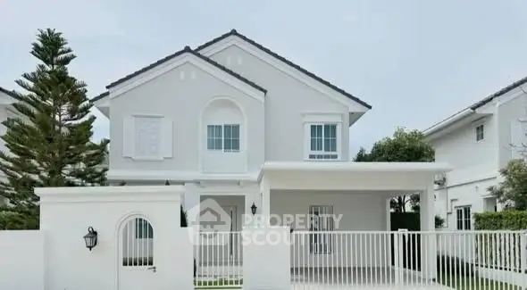 Charming two-story white house with elegant design and spacious front yard in a serene neighborhood.