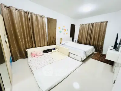 Spacious bedroom with twin beds and modern decor, perfect for comfort and relaxation.