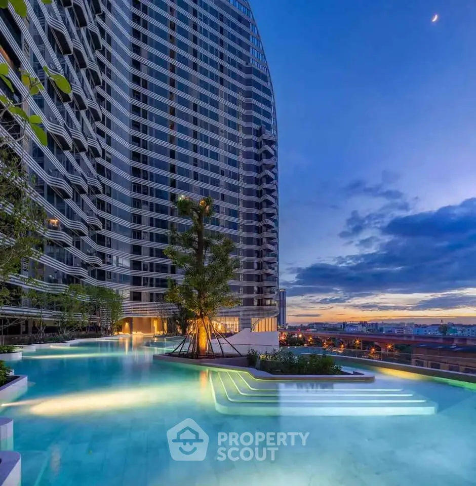 Luxurious high-rise building with stunning rooftop pool and breathtaking sunset view.