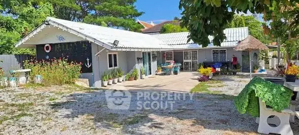 Charming single-story home with spacious outdoor area and lush greenery.
