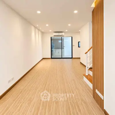 Spacious modern living room with wooden flooring and stylish lighting
