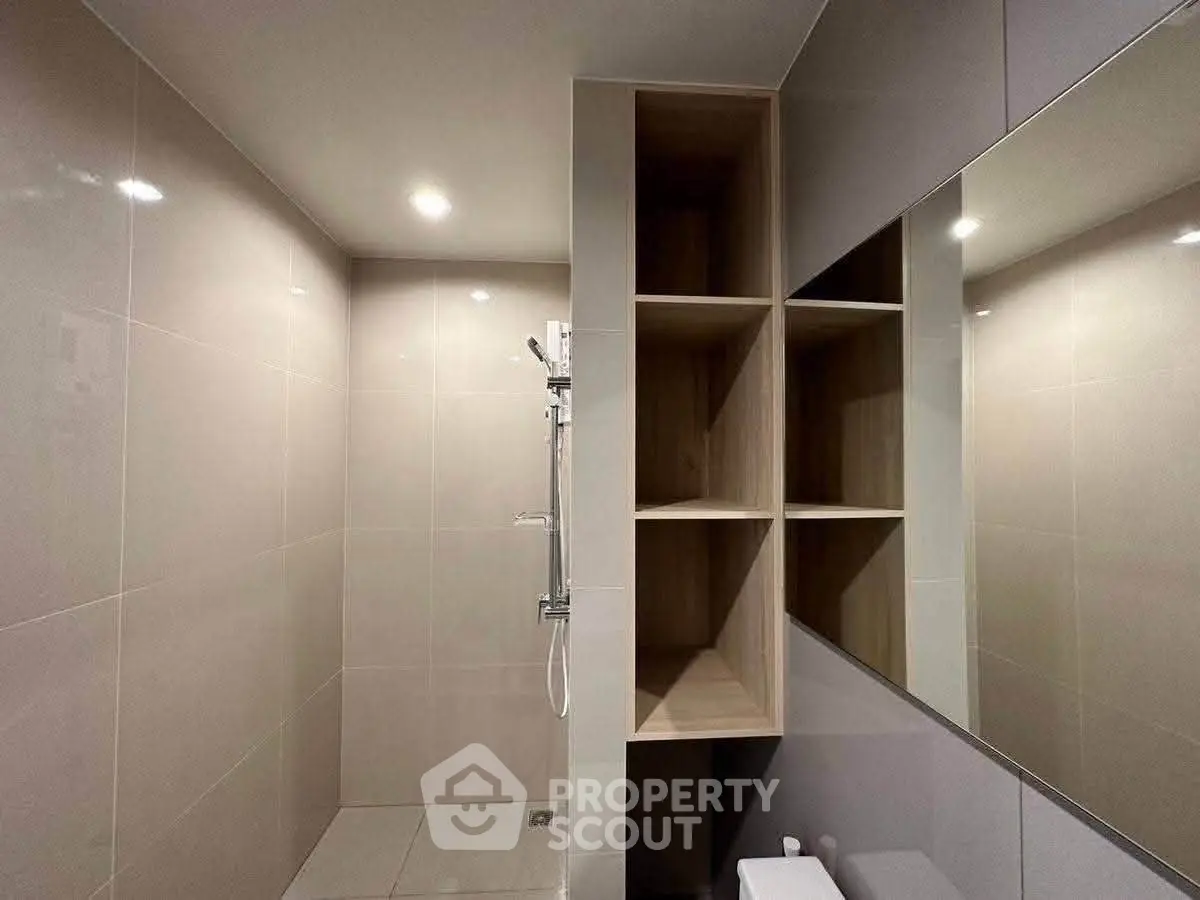 Modern bathroom with sleek shower and built-in shelving