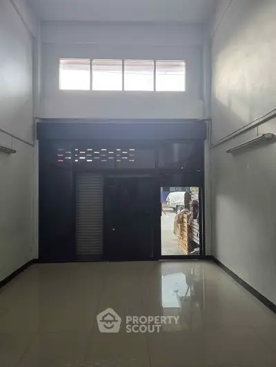 Spacious commercial space with high ceilings and large windows for natural light.