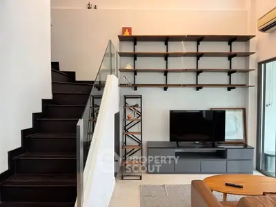 Modern living room with sleek staircase and stylish shelving unit