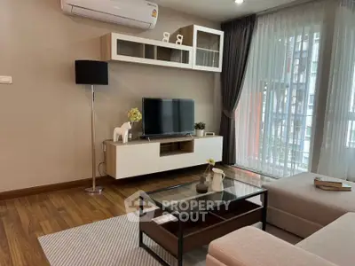 Modern living room with sleek furniture and large window view