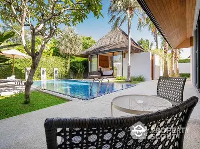 Luxurious villa with private pool and lush garden, perfect for relaxation and tropical living.