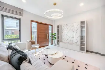 Luxurious modern living room with elegant chandelier and marble accents