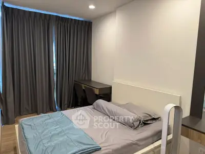 Modern bedroom with sleek design and cozy ambiance, featuring a comfortable bed and stylish furnishings.