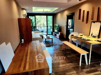 Stylish open-plan living and dining area with modern decor and balcony view.