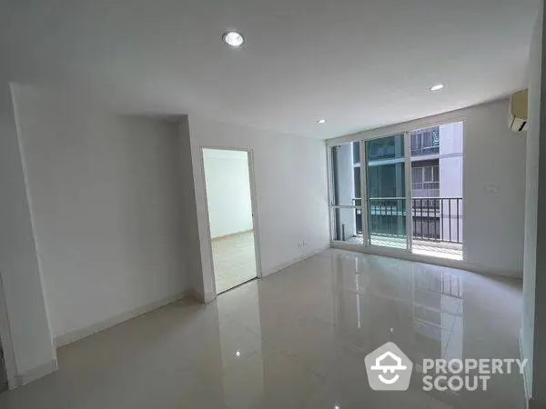 Spacious modern apartment with large windows and balcony access