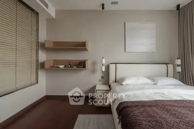 Modern bedroom with elegant decor and cozy ambiance, featuring a stylish bed and wooden flooring.