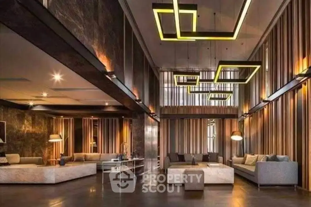 Luxurious modern living room with high ceilings and stylish lighting fixtures.