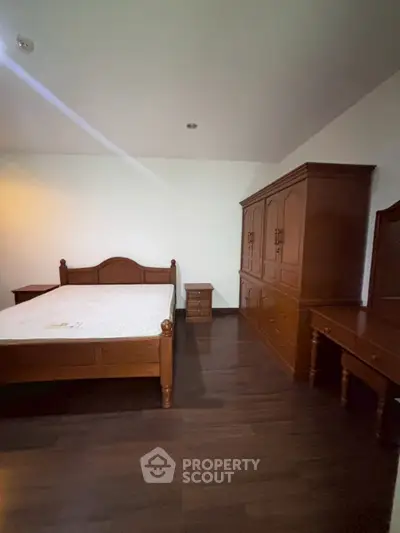 Spacious bedroom with elegant wooden furniture and modern design