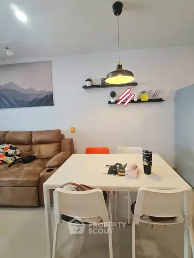Modern living room with cozy sofa and stylish dining area, perfect for urban living.
