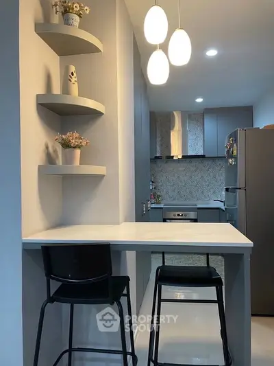 Modern kitchen with sleek design, featuring open layout and stylish lighting, perfect for contemporary living.