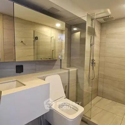 Modern bathroom with sleek design, glass shower, and elegant fixtures.