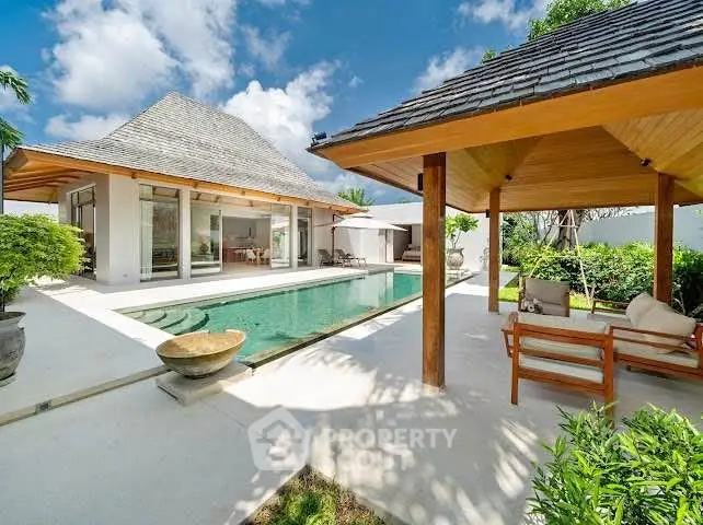 Luxurious villa with private pool and modern outdoor seating area, perfect for relaxation and entertainment.