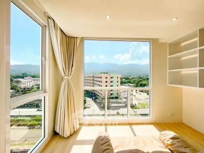Bright corner unit with panoramic mountain view, large windows, and elegant shelving.