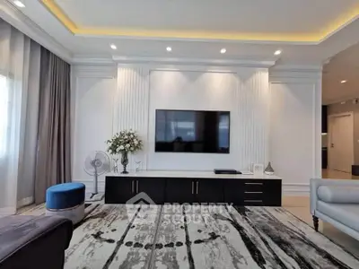 Luxurious living room with modern decor, featuring a sleek TV setup and elegant lighting.
