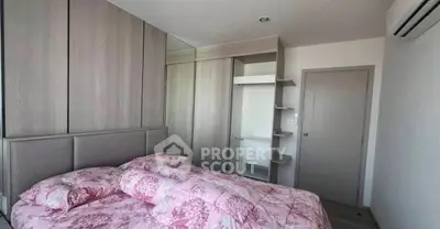 Cozy bedroom with mirrored wardrobe and floral bedding in modern apartment