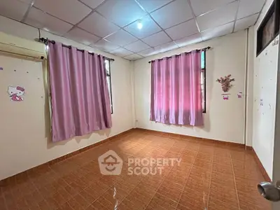Spacious empty room with tiled floor and pink curtains, perfect for customization.