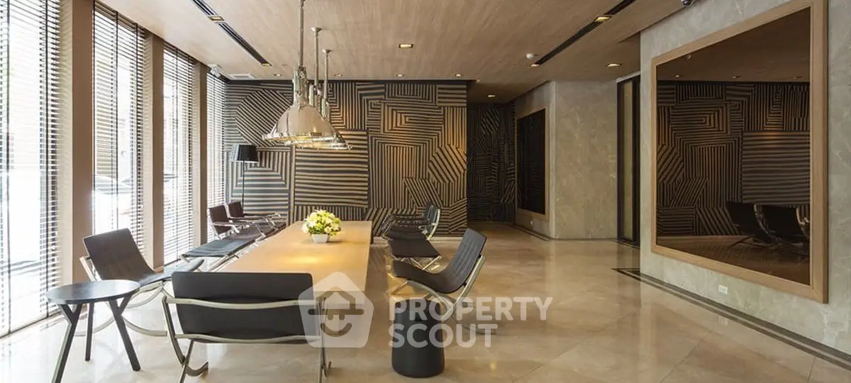 Luxurious modern living room with stylish decor and ample natural light, featuring elegant seating and a large mirror.