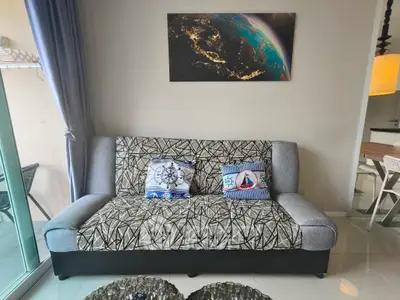 Modern living room with stylish sofa and balcony view