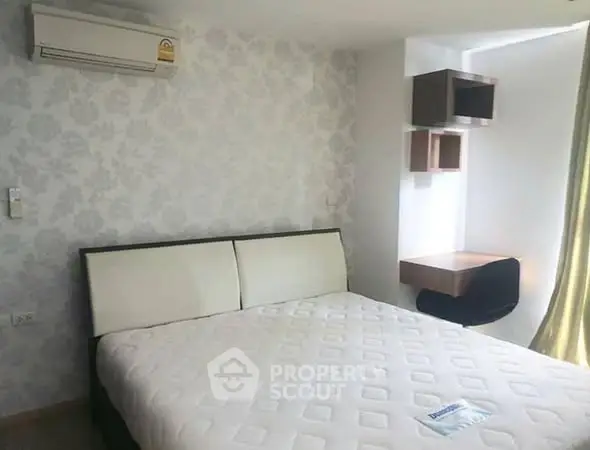 Modern bedroom with stylish wallpaper and air conditioning in a cozy apartment.