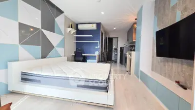 Modern bedroom with stylish decor and wall-mounted TV