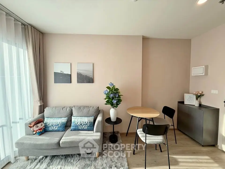Modern living room with cozy sofa, stylish decor, and natural light in a chic apartment.