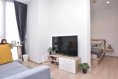 Modern living room with TV and cozy bedroom in open layout apartment