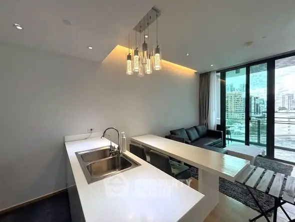 Modern open-plan kitchen and living room with city view balcony