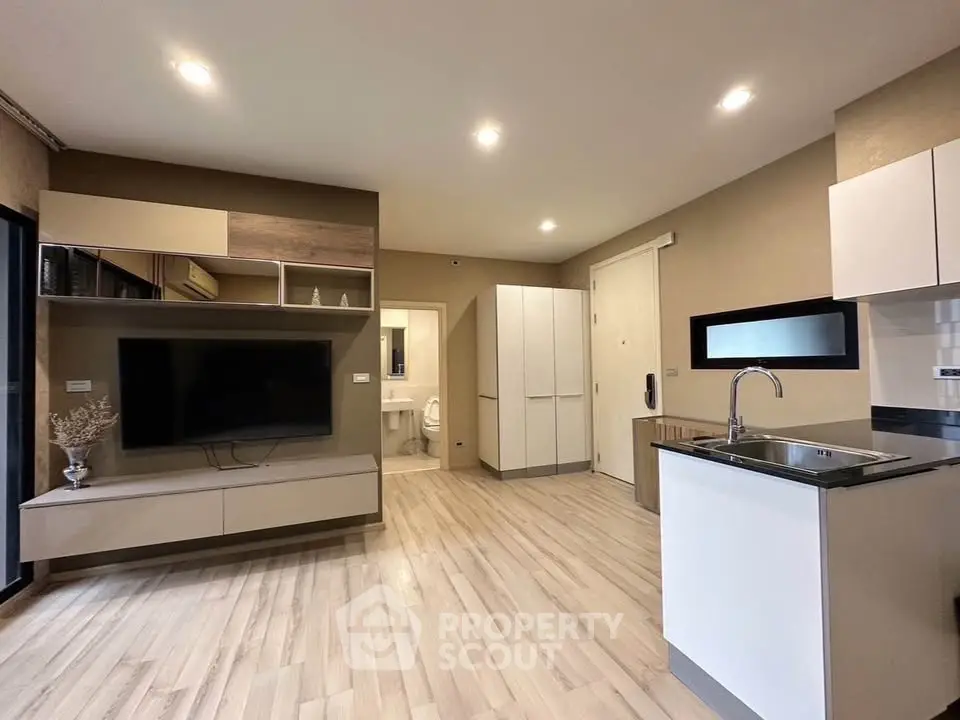 Modern open-plan living room with sleek kitchen and stylish decor
