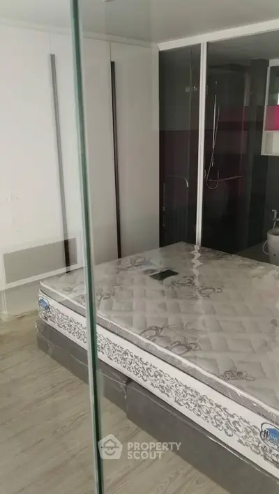 Modern bedroom with glass partition and stylish decor