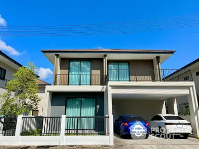 Modern two-story house with spacious driveway and two cars parked, featuring large windows and balcony.