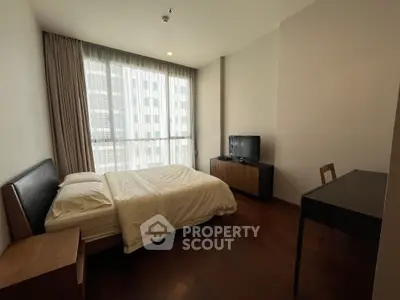 Modern bedroom with large window, wooden flooring, and minimalist furniture.